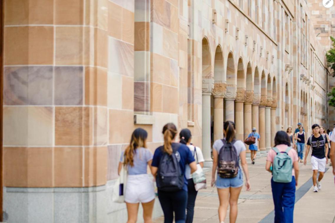 Students walking through the cloisters of UQ's Great Court. 