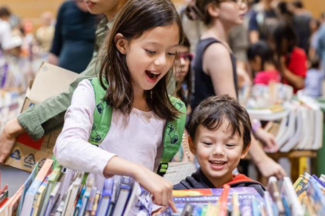 Children enjoying the books available at the Fair.